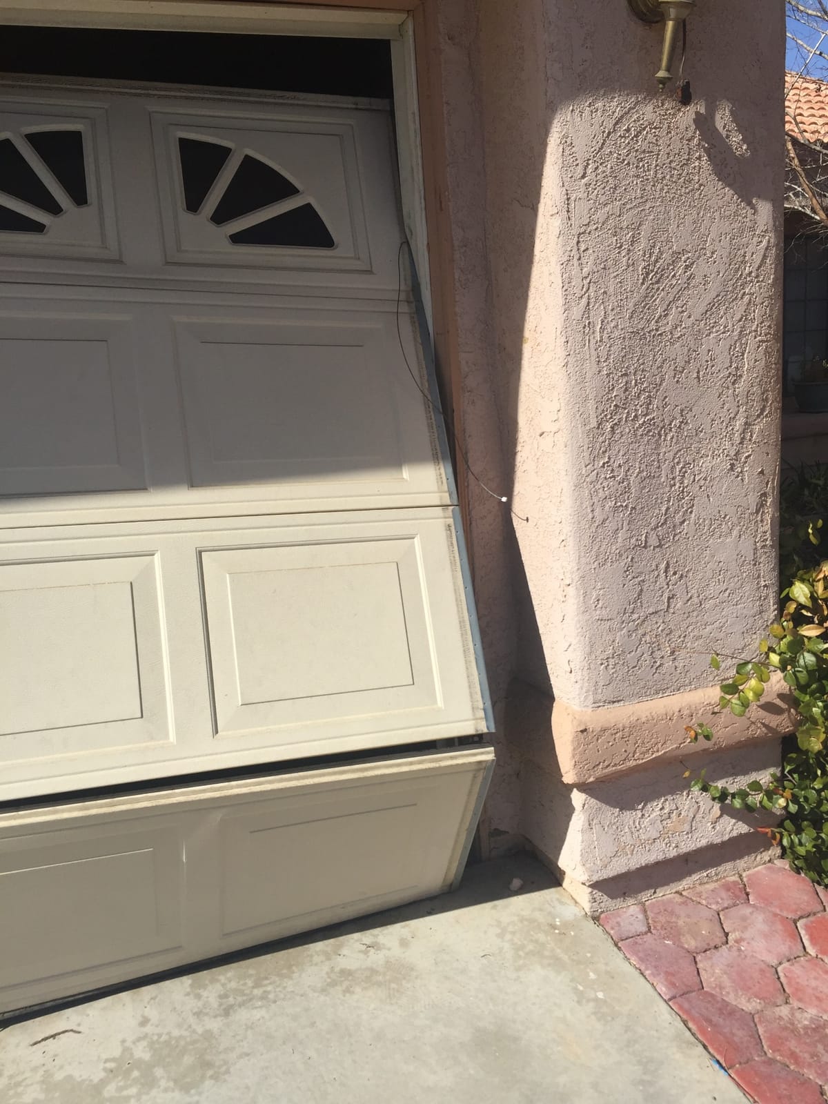 Crooked garage door off its track
