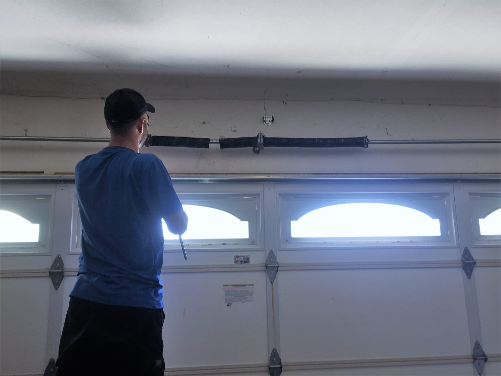 AER technician repairing a garage door in Los Angeles