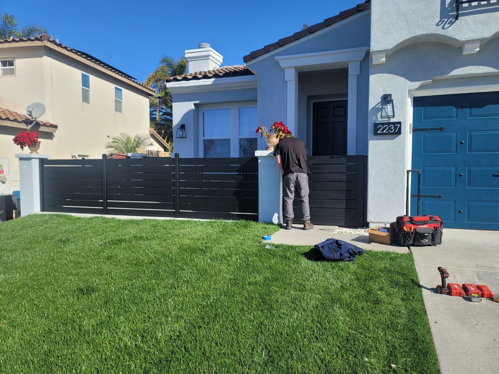Horizontal fence being installed in a front yard