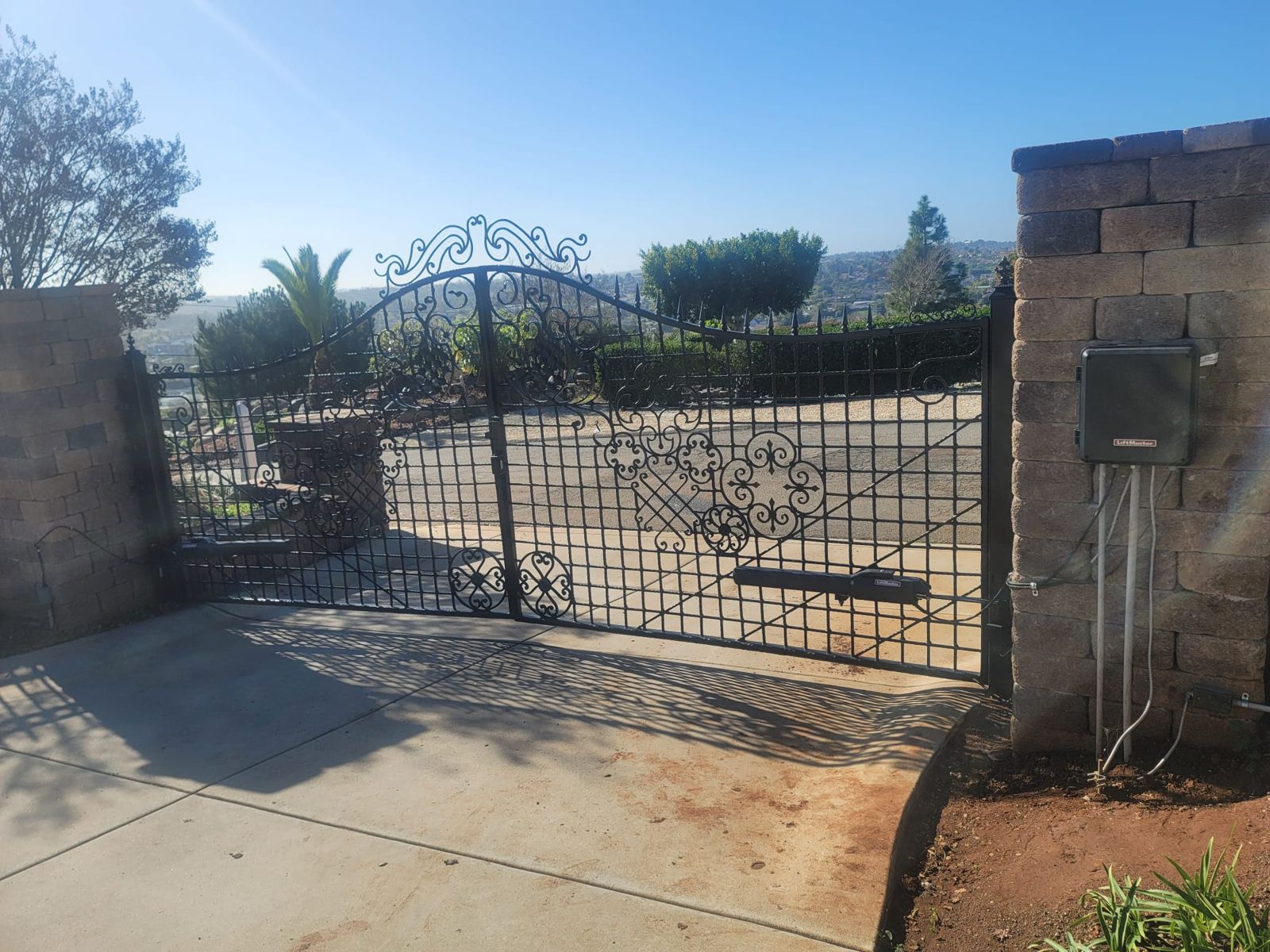 Wrought iron double gate with automatic operators