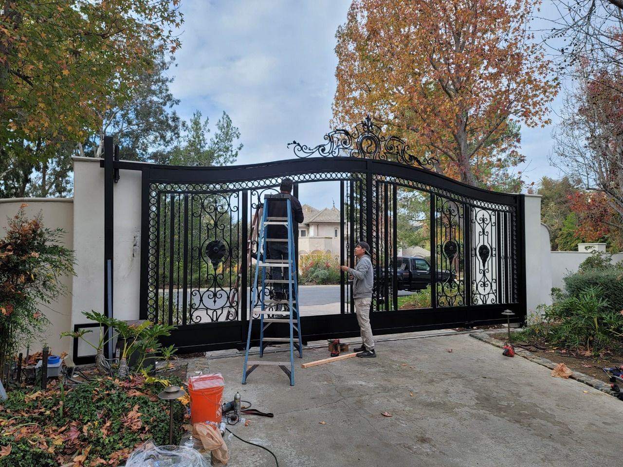 AER crew installing a wrought iron driveway gate