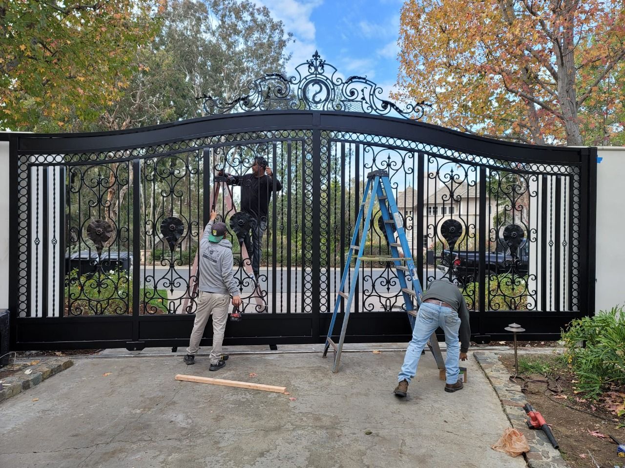 AER crew repairing a wrought iron driveway gate
